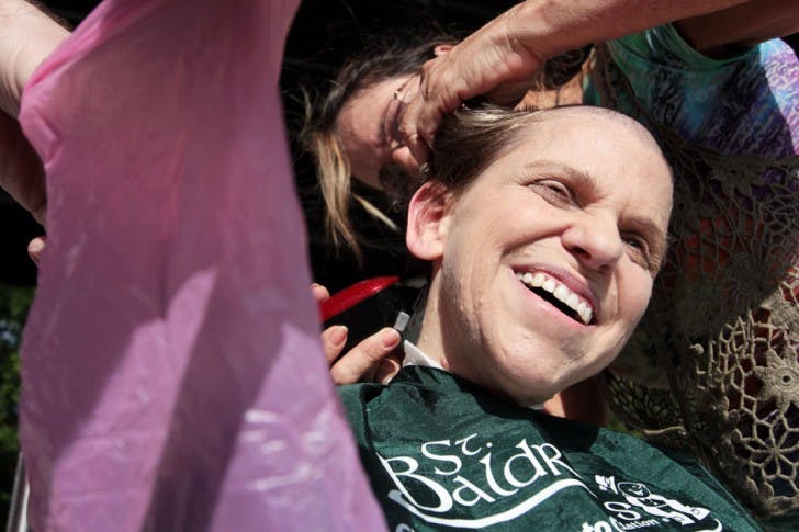 Renee Shifrin-Tannenholtz gets her head shaved on the bandshell of Flavet Field on Friday afternoon for the Freshman Leadership Council's first annual St. Baldrick's Day event. Shifrin-Tannenholtz raised $1,831 for children's cancer research.