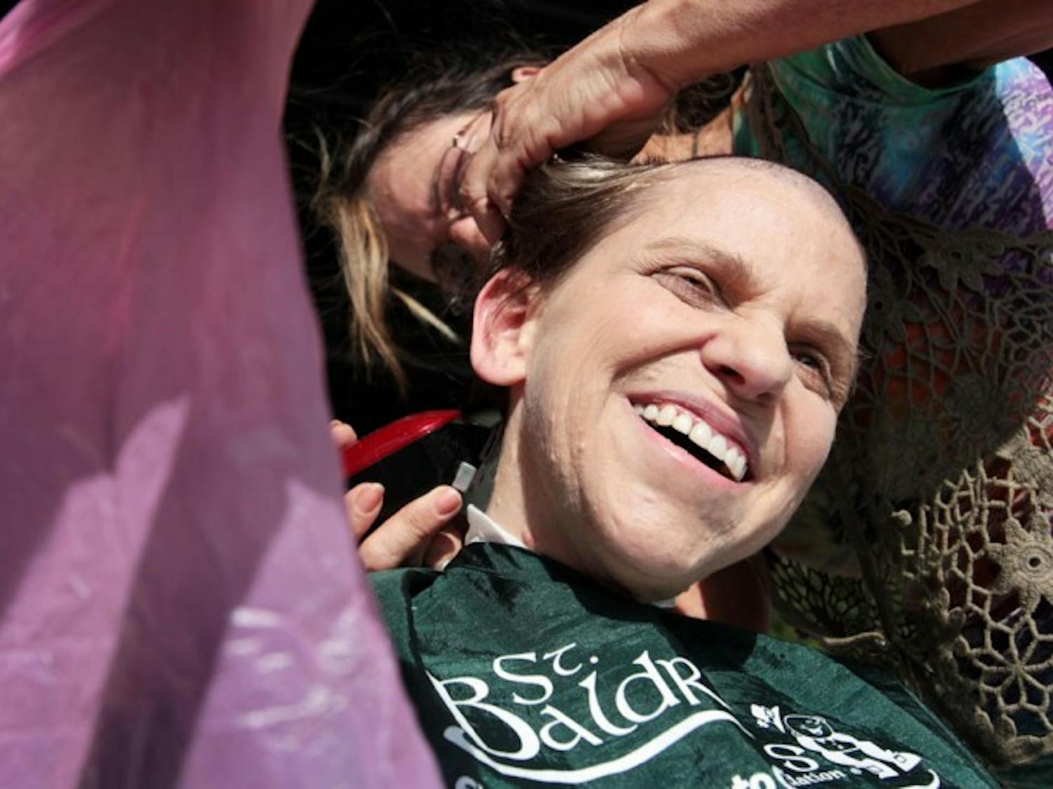 Renee Shifrin-Tannenholtz gets her head shaved on the bandshell of Flavet Field on Friday afternoon for the Freshman Leadership Council's first annual St. Baldrick's Day event. Shifrin-Tannenholtz raised $1,831 for children's cancer research.