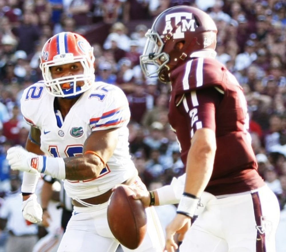 <p>Freshman linebacker Antonio Morrison(12) chases down Texas A&amp;M quarterback Johnny Manziel (2) at Kyle Field during Florida's 20-17 victory against Texas A&amp;M on Sept. 8.&nbsp;</p>