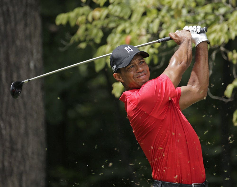 <p>FILE - In this Aug. 23, 2015, file photo, Tiger Woods watches his tee shot on the second hole during the final round of the Wyndham Championship golf tournament at Sedgefield Country Club in Greensboro, N.C. Tiger Woods has posted a video of him swinging a 9-iron in a golf simulator. His agent says the video was posted to rebut rumors on social media that he had taken a turn for the worse following two back surgeries last fall. Mark Steinberg of Excel Sports Management said Monday, Feb. 22, 2016, that the rumors were ridiculous. (AP Photo/Chuck Burton, File)</p>