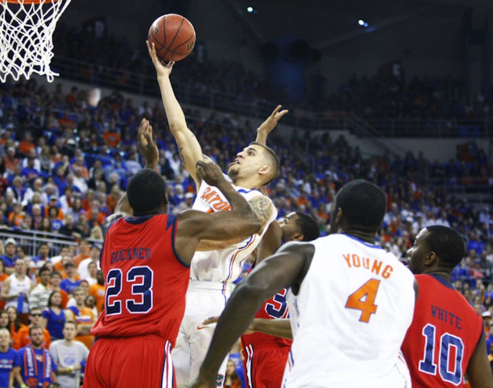 <p align="justify">Florida guard Scottie Wilbekin attempts a shot against Ole Miss forward Reginald Buckner during the Gators’ 78-64 win against the Rebels on Saturday at the O’Connell Center.</p>