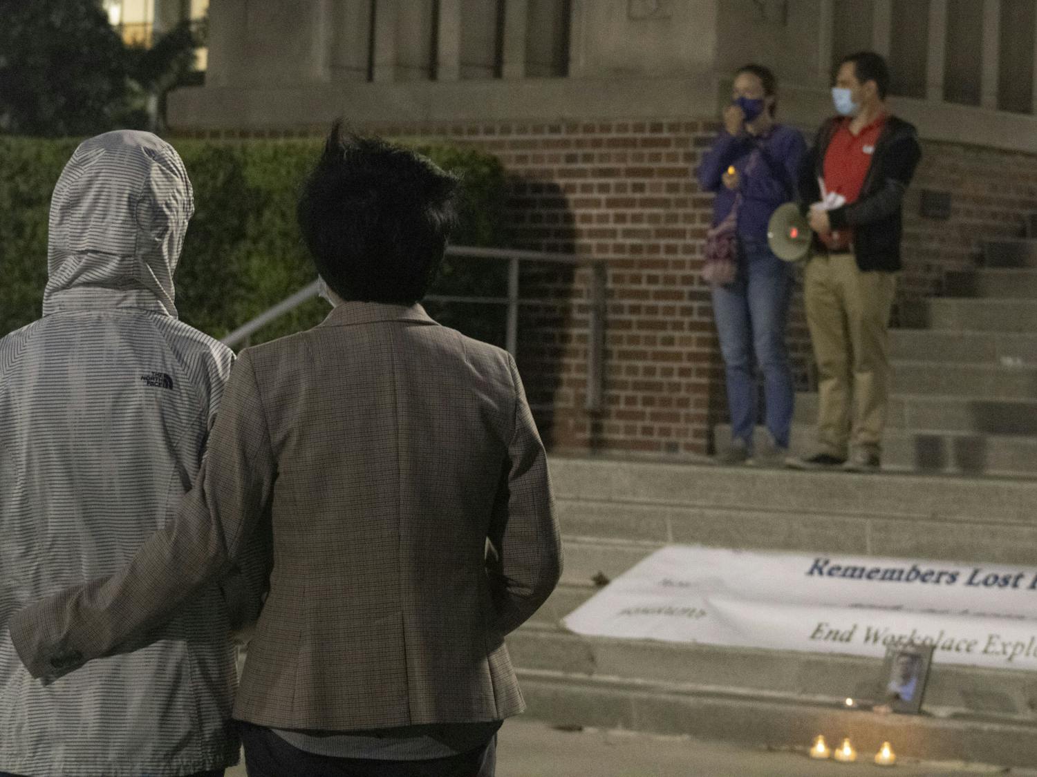 Two attendees stand in front of Tigert Hall at UF during a vigil on Thursday, April 1 honoring the life of international graduate student Huixiang Chen, who died by suicide in 2019. UF's Graduate Assistants United organized the event to express frustrations over abusive graduate student-mentor relationships.
