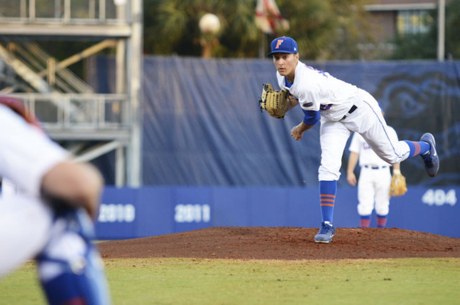 Left-handed pitcher Danny Young (15) warms up between innings during Florida’s 4-1 loss to Florida State on March 12 at McKethan Stadium. The freshman allowed two hits in four innings against the Seminoles on Tuesday night.