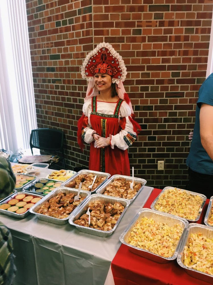 UF Russian Culture Club president Daria Bulatnikova serves food at their annual fall festival, which changes themes each year.