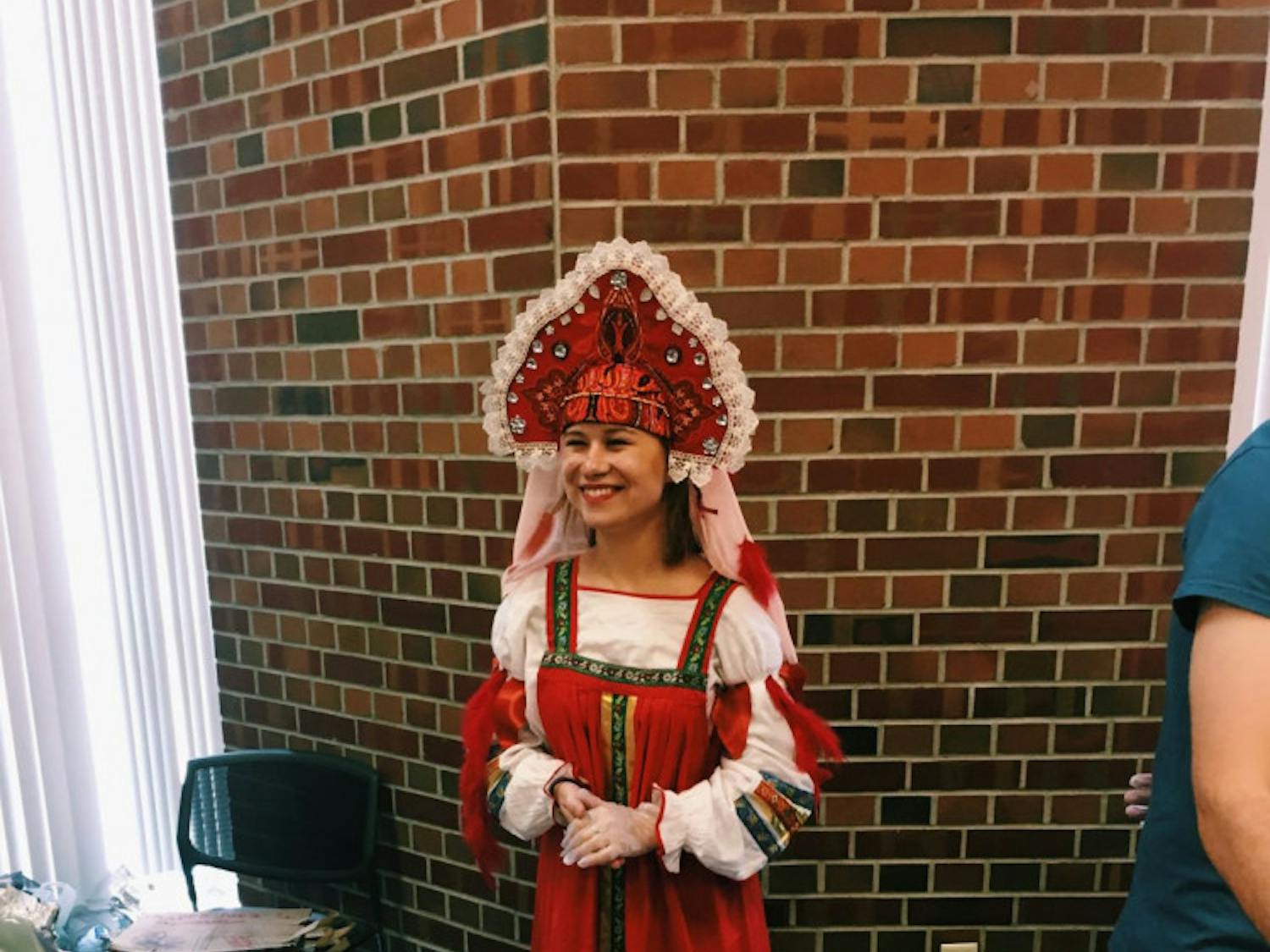 UF Russian Culture Club president Daria Bulatnikova serves food at their annual fall festival, which changes themes each year.
