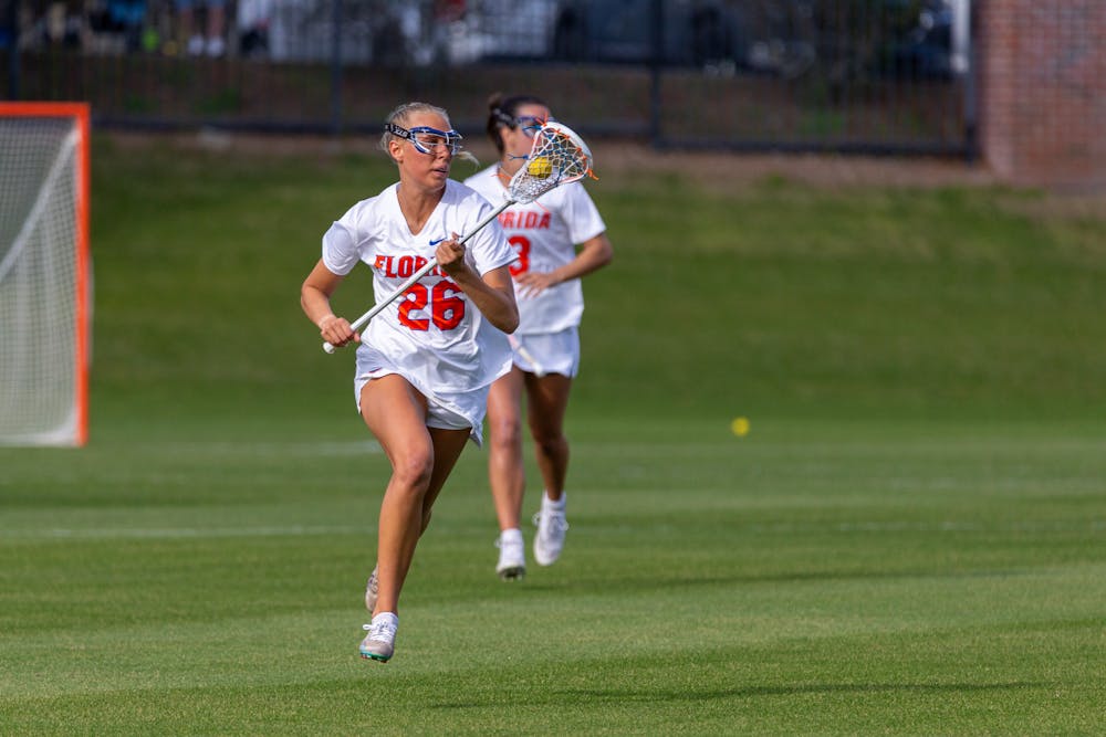 Freshman defender Ashley Dyer runs up the field during the Florida Gators’ Lacrosse game against the Jacksonville Dolphins on Wednesday, February 28. Photo by Ryan Friedenberg