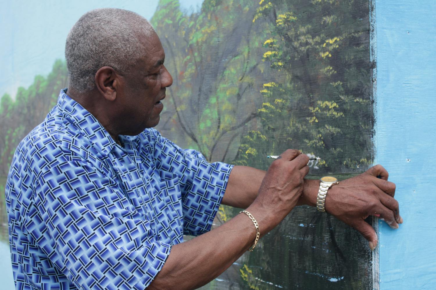  Al Black signs his name as the finishing touch on the Highwaymen mural Wednesday, Aug. 23, 2022.