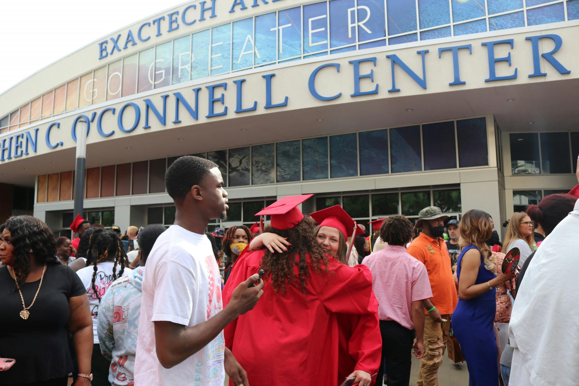 Two graduates congratulate each other outside of the O’Connell Center after the Sante Fe High School Commencement Ceremony on May 27, 2022. 