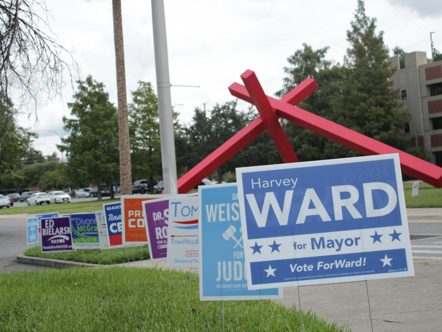 Campaign signs line the street outside of the Florida Museum of Natural History polling location Tuesday, Aug. 23, 2022.