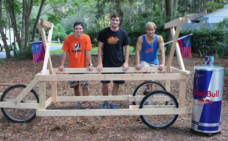 Pilot Max Famiglietti (left), Chris Roda (center) and Rocky Flood (right) pose next to the work-in-progress glider they are entering into the National Red Bull Flugtag competition in Miami. Team members Aaron Alanguilan and Jon Kistemaker are not pictured.