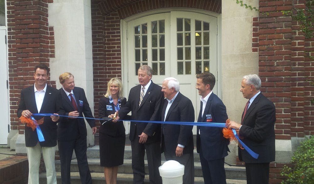 John Kraft, far right, Dean of the Warrington College of Business, watches during the ribbon-cutting of the newly renovated Kelley A. Bergstrom Center for Real Estate Studies at Bryan Hall in September 2015.&nbsp;