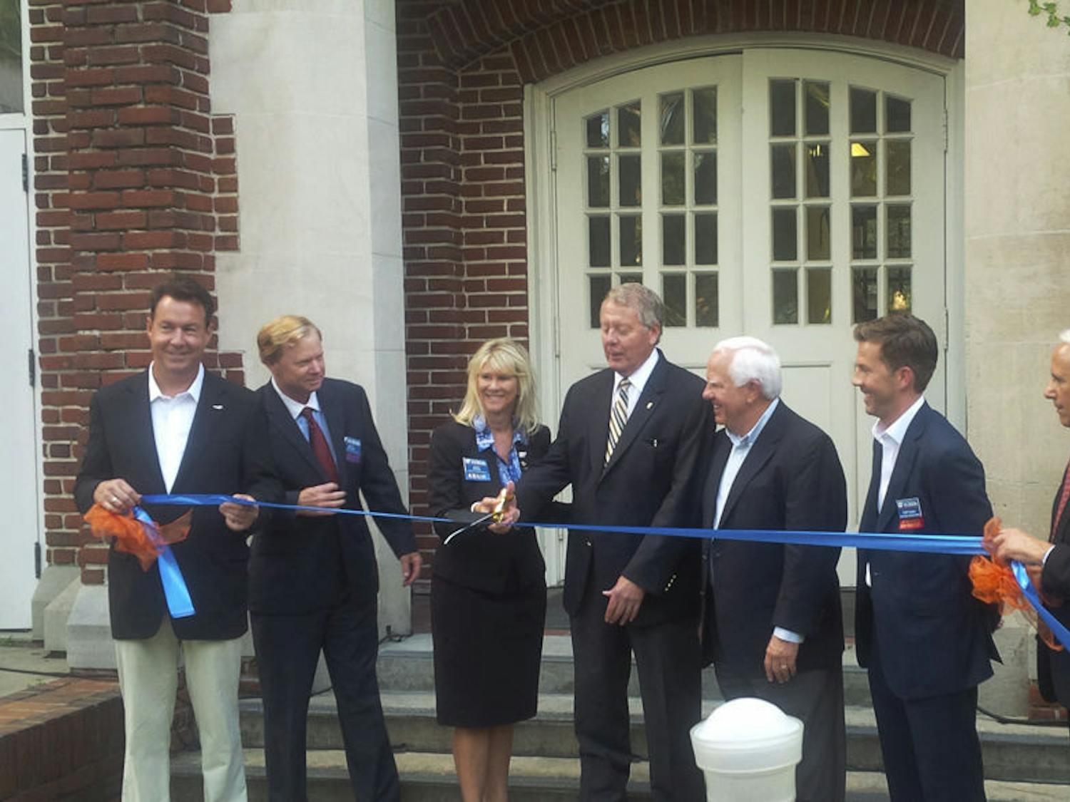 John Kraft, far right, Dean of the Warrington College of Business, watches during the ribbon-cutting of the newly renovated Kelley A. Bergstrom Center for Real Estate Studies at Bryan Hall in September 2015. 