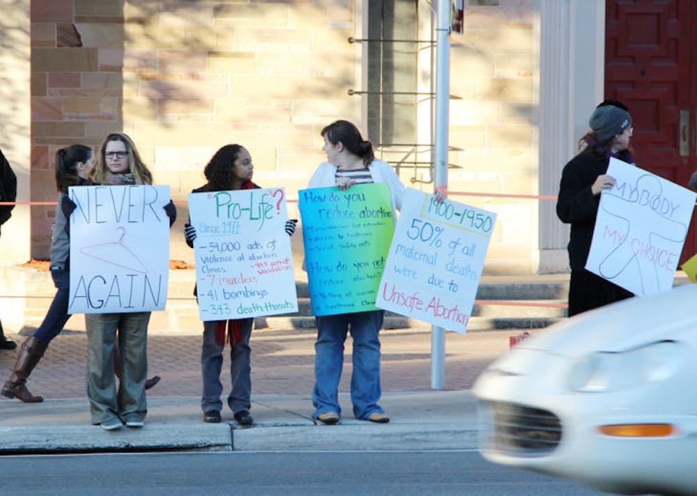 <p class="p1">Protesters line up in front of St. Augustine Church on W. University Avenue Wednesday afternoon to&nbsp; acknowledge the 41st anniversary of the Roe v. Wade decision of 1973.</p>