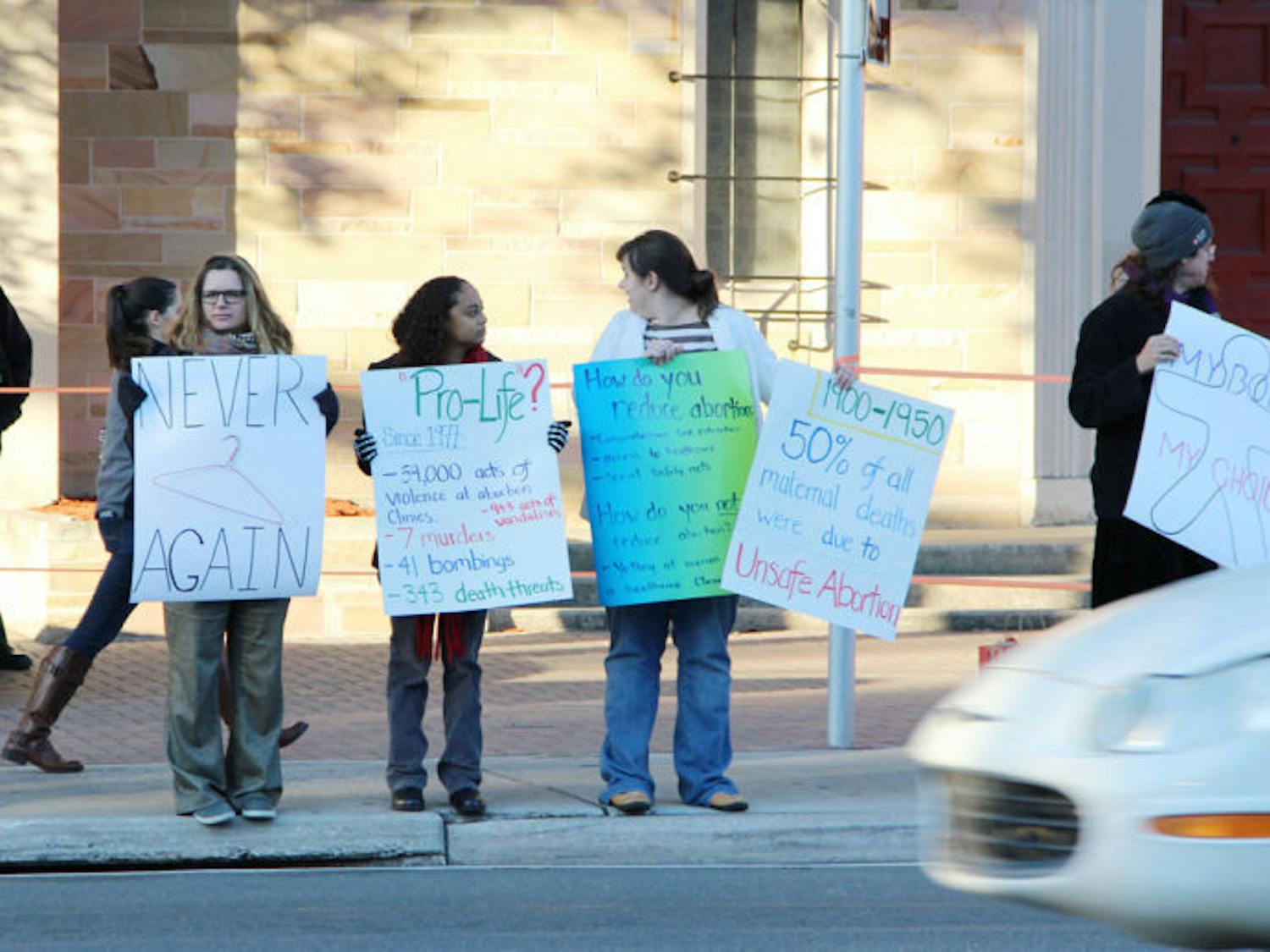 Protesters line up in front of St. Augustine Church on W. University Avenue Wednesday afternoon to acknowledge the 41st anniversary of the Roe v. Wade decision of 1973.
