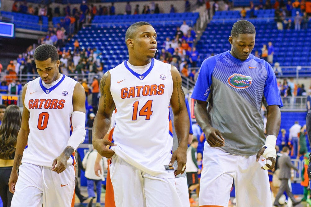 <p>Kasey Hill (left), Lexx Edwards and Dorian Finney-Smith walk off the O'Connell Center floor following Florida's 69-67 loss to Miami on Monday.</p>