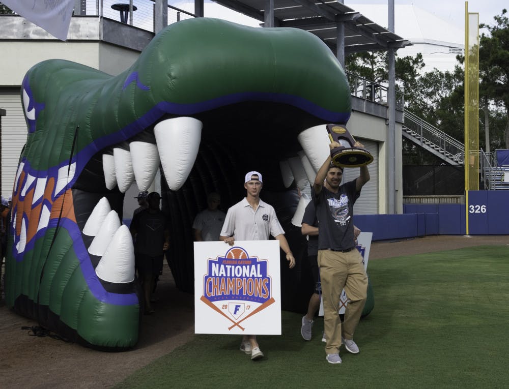 Alex Faedo hoists the NCAA Tournament trophy on Wednesday night during UF’s championship celebration at McKethan Stadium.