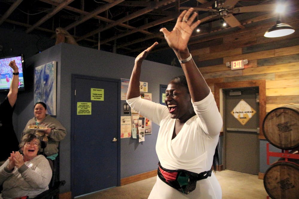 Gail Johnson, 40, celebrates winning City Commission at-large seat 1 after getting off the phone with her opponent, Harvey Budd, who conceded inside First Magnitude Brewing Company. 