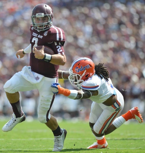 Quarterback Johnny Manziel (2) eludes Josh Evans during UF’s 20-17 win at Texas A&amp;M on Sept. 8.