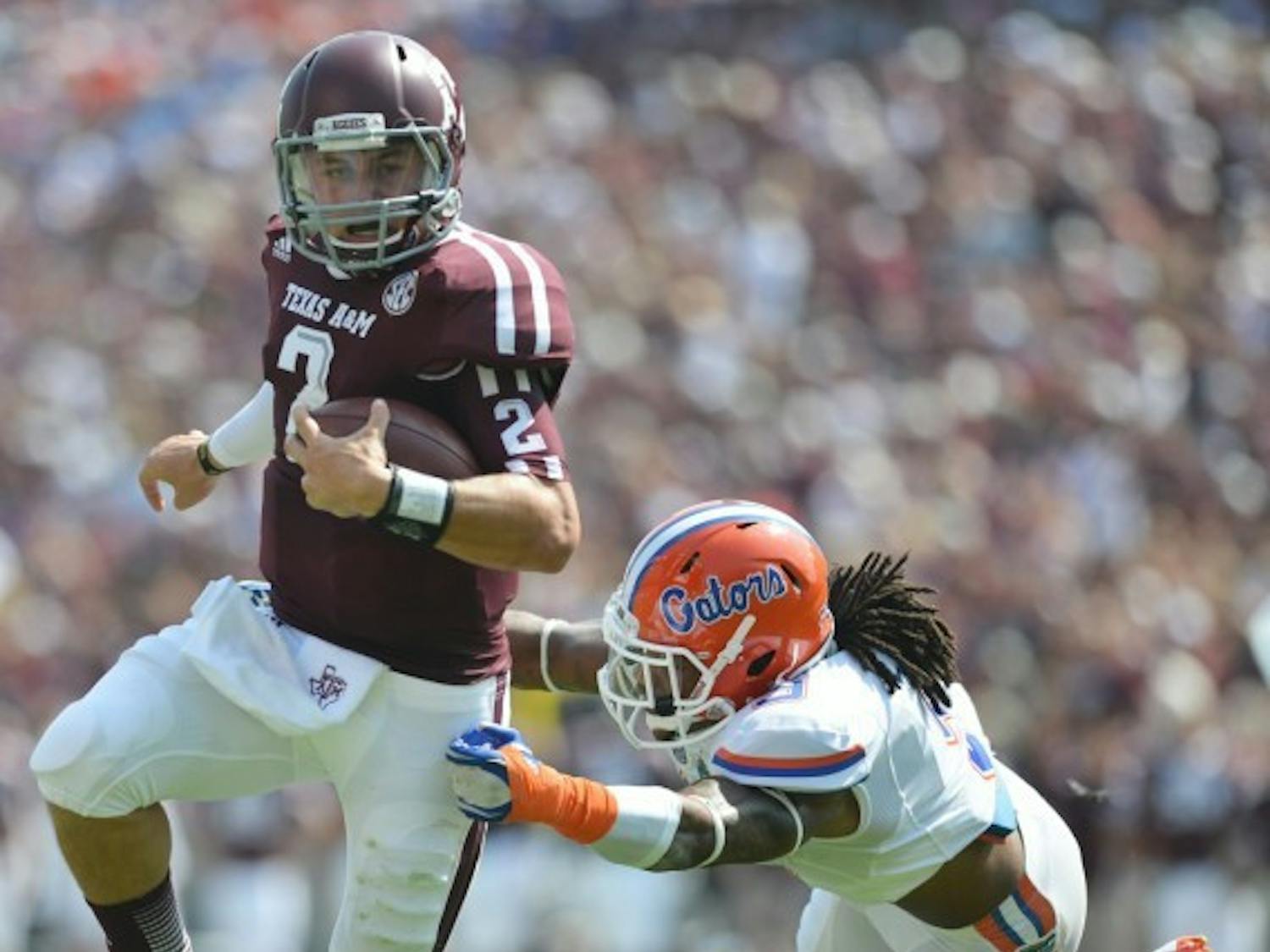 Quarterback Johnny Manziel (2) eludes Josh Evans during UF’s 20-17 win at Texas A&M on Sept. 8.
