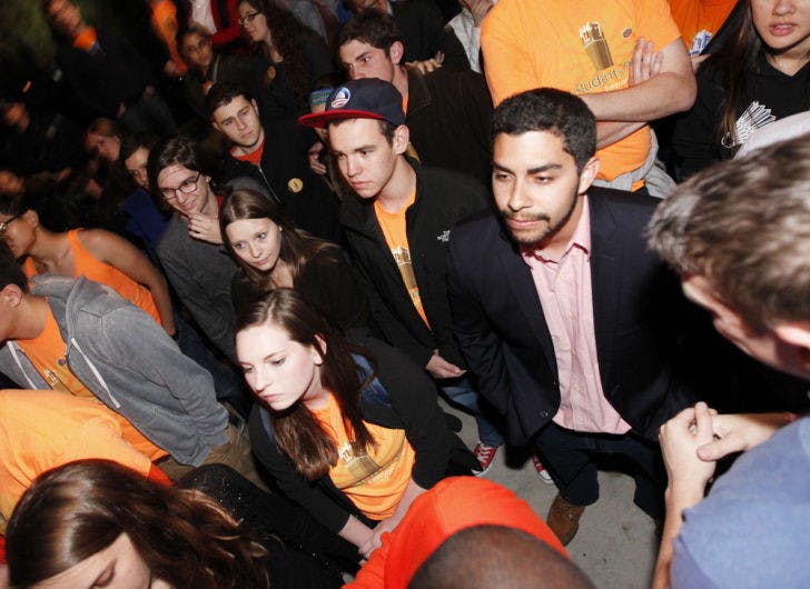 Students Party presidential candidate Johnny Castillo, center right, reacts to the results of the Student Government elections at the Reitz Union on Feb. 20, 2013. The Swamp Party won by 3,180 votes.