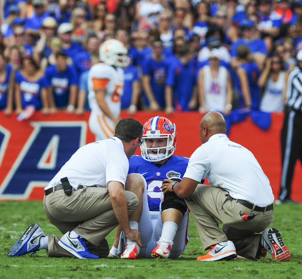 <p class="p1">Two trainers tend to quarterback Jeff Driskel after he suffered a fractured right fibula during Florida's 31-17 victory against Tennessee on Sept 21, 2013 in Ben Hill Griffin Stadium.</p>