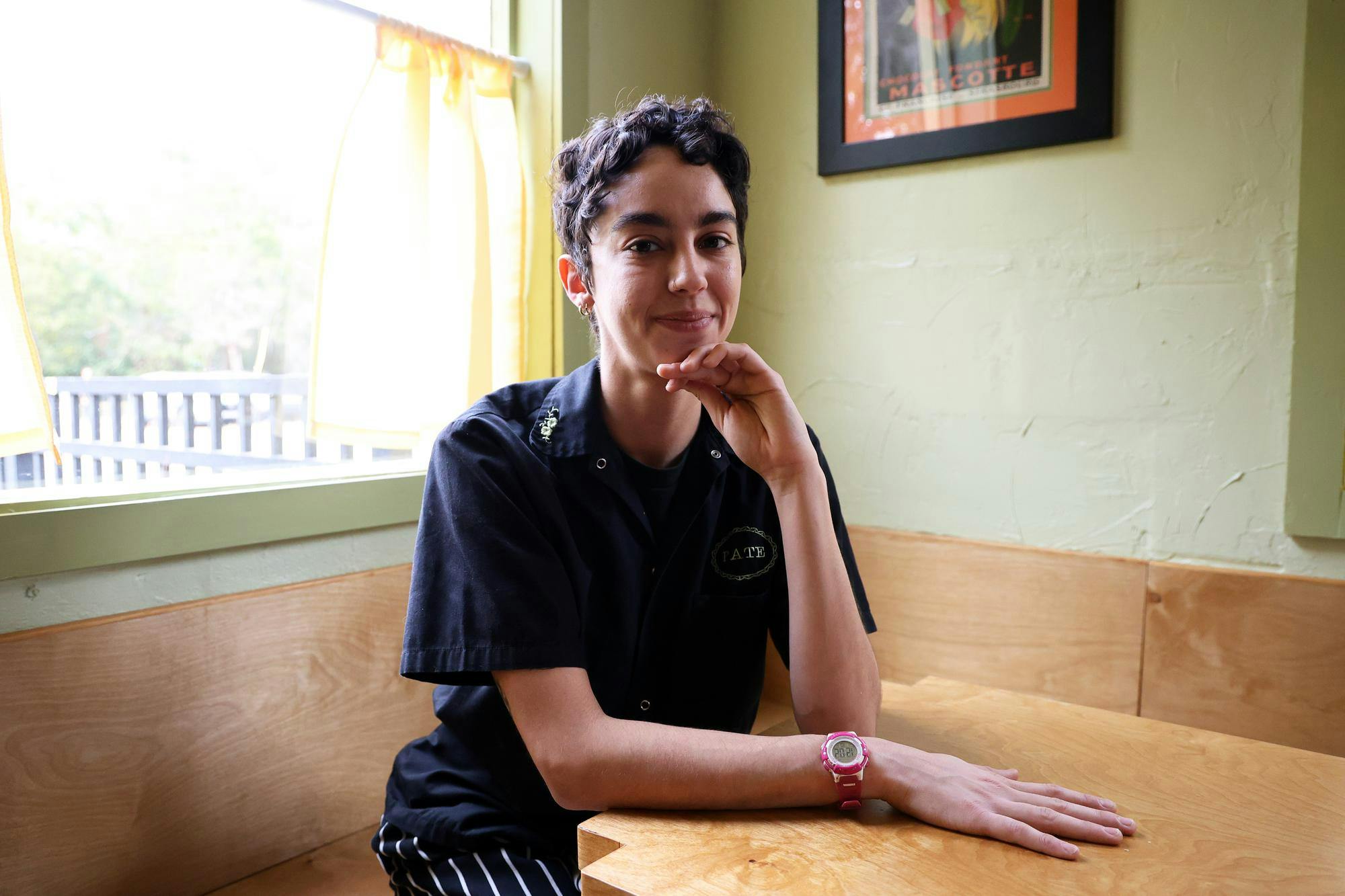Peyton Agliata, owner of Bushel and Peck, sits inside Bushel and Peck and Lowbar in Gainesville, Fla., Saturday. Jan. 24, 2026.