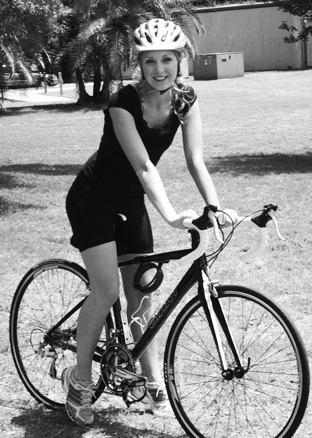 Grace Tidwell, a 2010 UF graduate, poses on a bicycle. Tidwell will be biking North Carolina to California, with Bike and Build, a nonprofit organization that builds affordable housing.