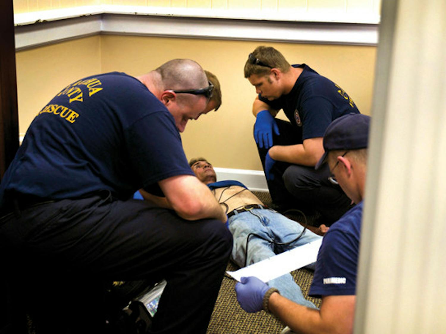 911 first responders treat a homeless man who was getting a check-up at the clinic when he started to feel chest pains on Mar. 21, 2011.