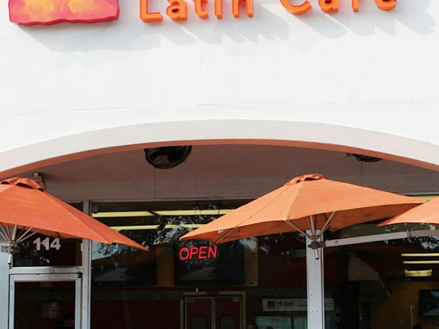 Patrons Tammy Bernard, left, and Jenny Lee, right, eat a meal outside Mi Apa Latin Cafe on 34th Street. The cafe will open a second location Monday in Alachua at 15634 NW Highway 441.