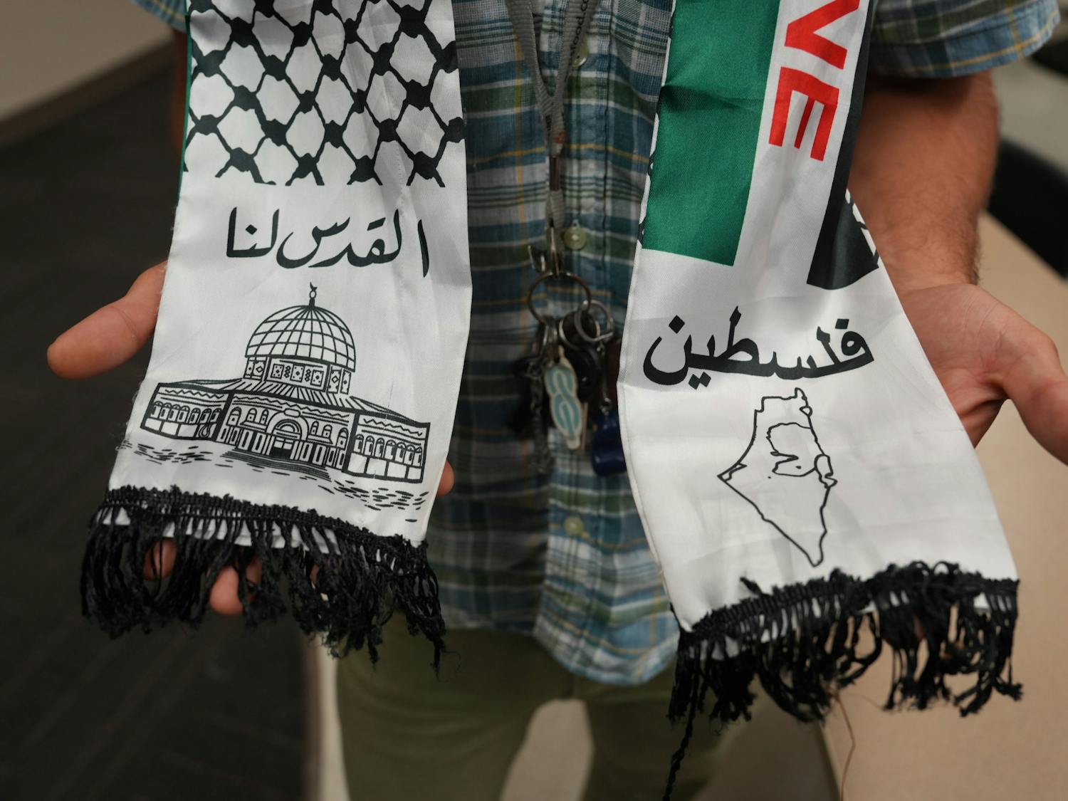 Majd Afaghani, attends UF SJP’s discussion in Turlington wearing a Palestine kufiyyeh neck scarf on Thursday Oct. 12, 2023.