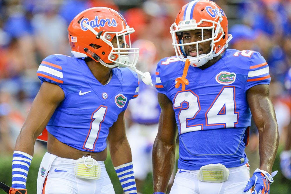 <p>Vernon Hargreaves (1) talks to Brian Poole (24) during Florida's 36-30 win against Kentucky on Saturday at Ben Hill Griffin Stadium.</p>