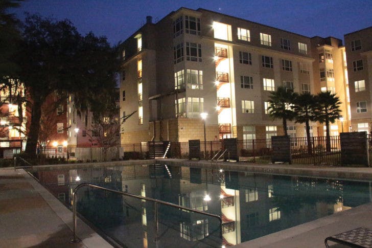 The community pool at the Continuum is empty Sunday evening. The student complex, considered UF-affiliated housing, recently faced resident complaints about verbal agreements and lease cancellations.
