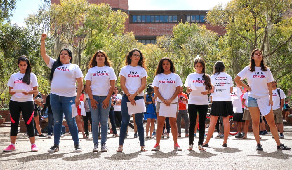 Eight students stand in a line on Turlington Plaza and break down stereotypical labels associated with the Hispanic community. The demonstration, hosted by the Hispanic Student Association, was also aimed at encouraging observers to vote.