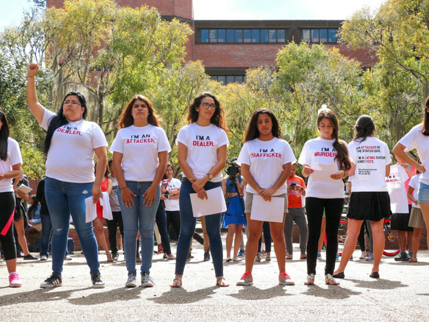 Eight students stand in a line on Turlington Plaza and break down stereotypical labels associated with the Hispanic community. The demonstration, hosted by the Hispanic Student Association, was also aimed at encouraging observers to vote.