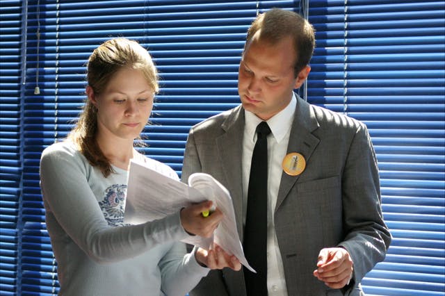 Senate minority leader Gillian Leytham and Jonathan Ossip of the Students Party review elections records at the election commission meeting Friday. The commission voted unanimously to validate election results. The Students Party has chosen to appeal the ruling.