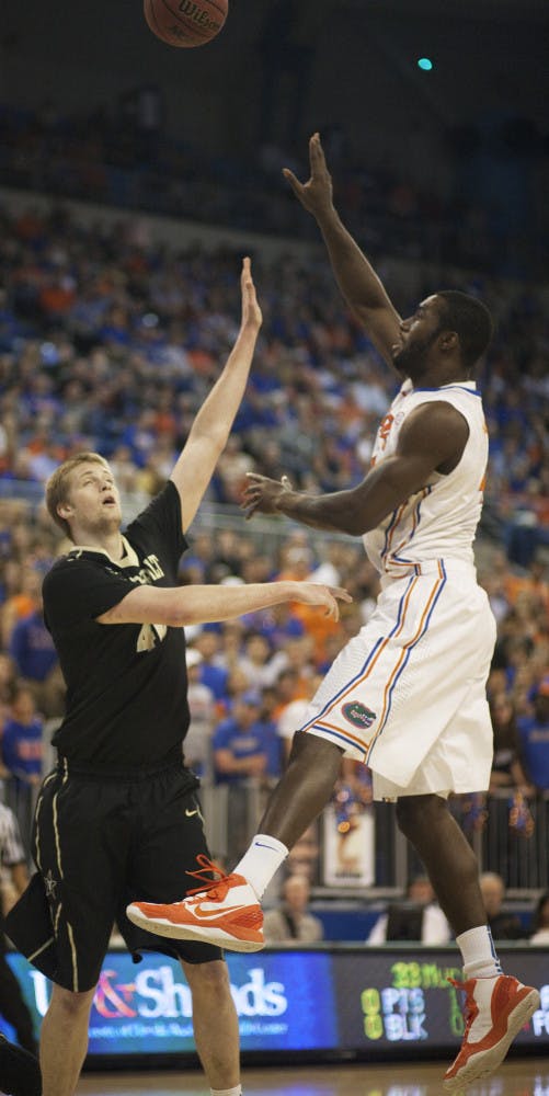 Junior center Patric Young (right) attempts a hook shot during Florida’s 66-40 win against Vanderbilt on March 6 in the O’Connell Center. .
