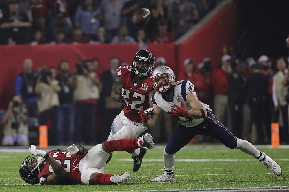 New England Patriots' Julian Edelman eyes the ball before making the catch as Atlanta Falcons' Robert Alford, left, and Keanu Neal defend, during the second half of Super Bowl 51 in Houston. (Patrick Semansky/AP)