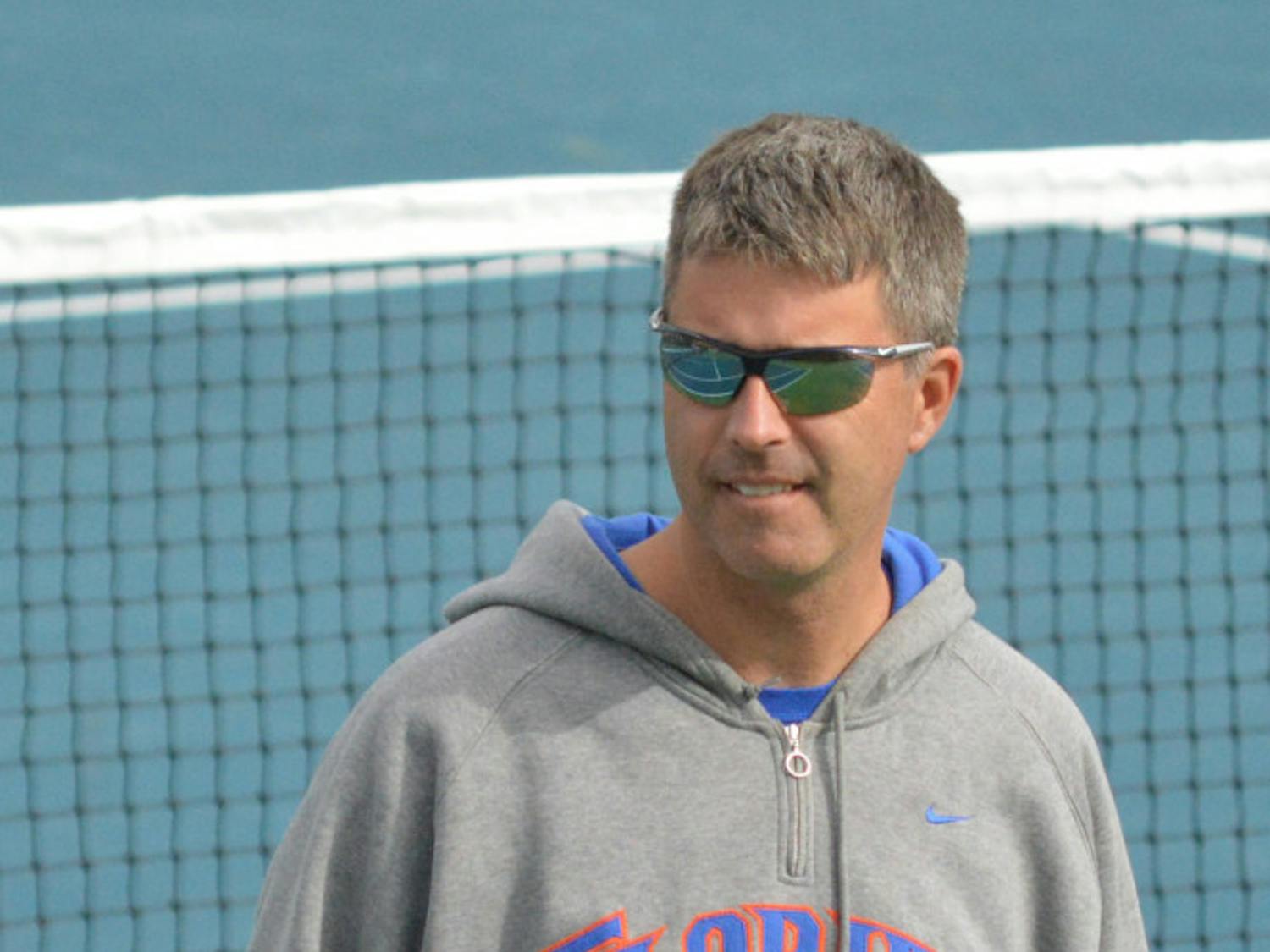 Coach Roland Thornqvist looks down the courts of the Ring Tennis Complex during Florida's 4-0 win against Louisville on Aug. 25.