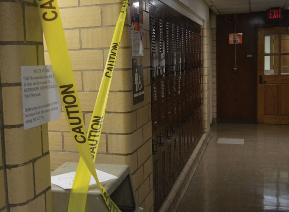 <p>A women’s restroom in Norman Hall is marked off with caution tape on Sept 10, 2013. The building had no running water, and students were being directed to Norman Hall’s new addition, the Digital Worlds Institute next door.</p>