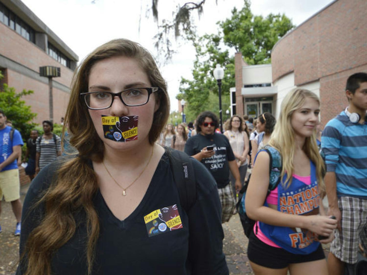 Kerry Stern, a 21-year-old UF economics major, stands in silence with her peers as part of the Day of Silence in support of LGBTQ students on Turlington Plaza on Friday afternoon.