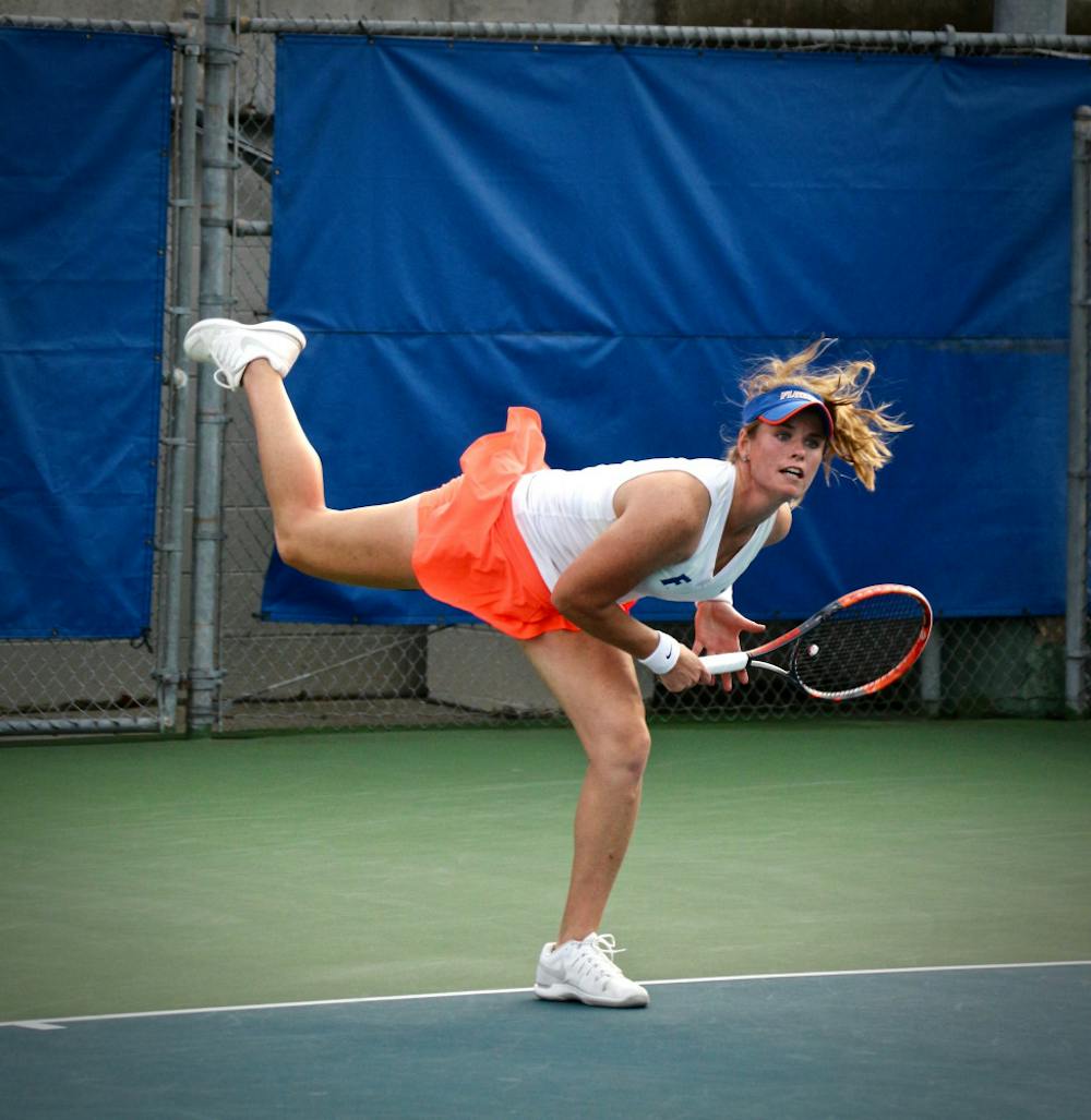 <p>Belinda Woolcock serves during Florida's 4-2 win over Oklahoma State on Feb. 18, 2017, at the Ring Tennis Complex.</p>
