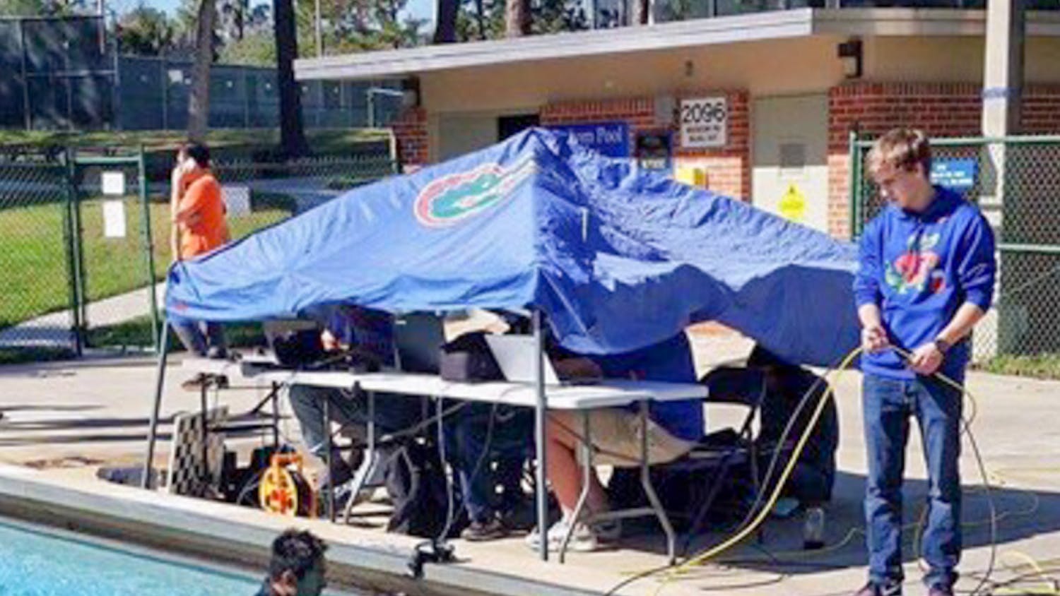 Members of Project GATOR test their “subjugator” underwater robot in a pool by Graham Hall. The group received a $6,000 grant from the U.S. Department of State to help build the machine, which searches for abandoned crab fishing traps.