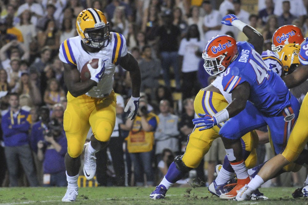 <p>LSU running back Leonard Fournette carries the ball as he's chased by UF linebacker Jarrad Davis (40) during the Tigers' 35-28 win against the Gators on Oct. 17, 2015, at Tiger Stadium in Baton Rouge, Louisiana.</p>