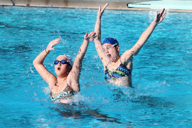 Lauren, 13, and Bonnie, 12, practice synchronized swimming in the Dwight H. Hunter Municipal Pool on Saturday. The Synchro Gainesville team is preparing for the NE/NW Association Championship on April 27 and 28 in Cocoa Beach.