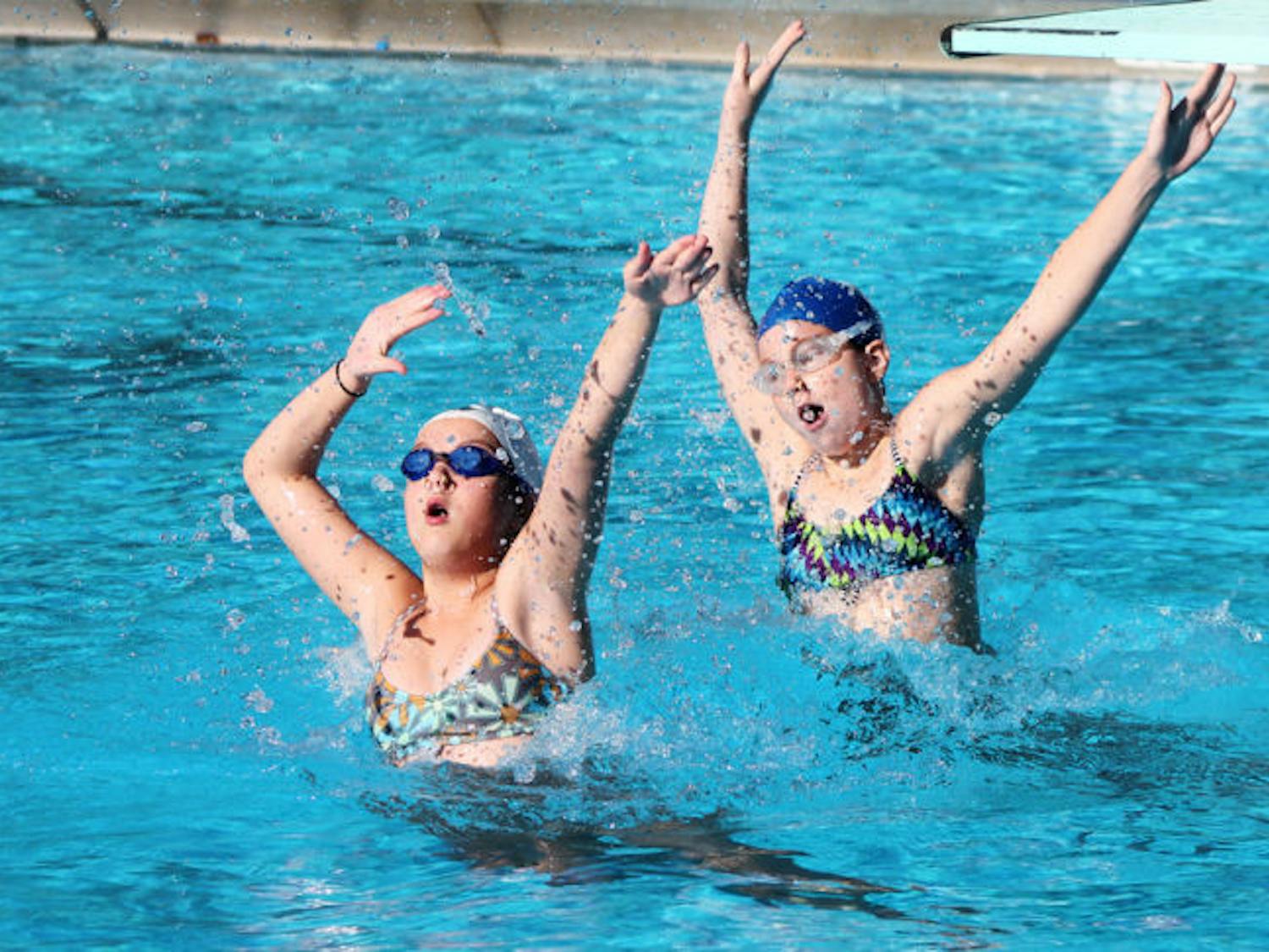 Lauren, 13, and Bonnie, 12, practice synchronized swimming in the Dwight H. Hunter Municipal Pool on Saturday. The Synchro Gainesville team is preparing for the NE/NW Association Championship on April 27 and 28 in Cocoa Beach.