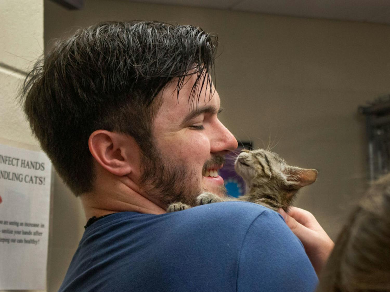 Jacob Floyd smiles at his new 2-month-old kitten Saturday morning at the Summer Lovin’ Adopt-A-Thon.