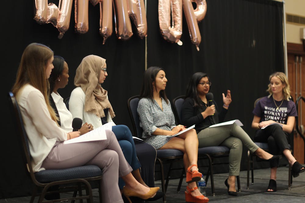 <p>(Left to right) Panelists Julia Van de Bogart, Mira Lowe, Sana Nimer, Diana Moreno and Dhara Patel talk with a UF Women’s Student Association member about women empowerment in the workplace, women standing up for themselves and encouraging other women during a discussion Sunday in the Reitz Union Grand Ballroom. About 70 people attended the talk.</p>