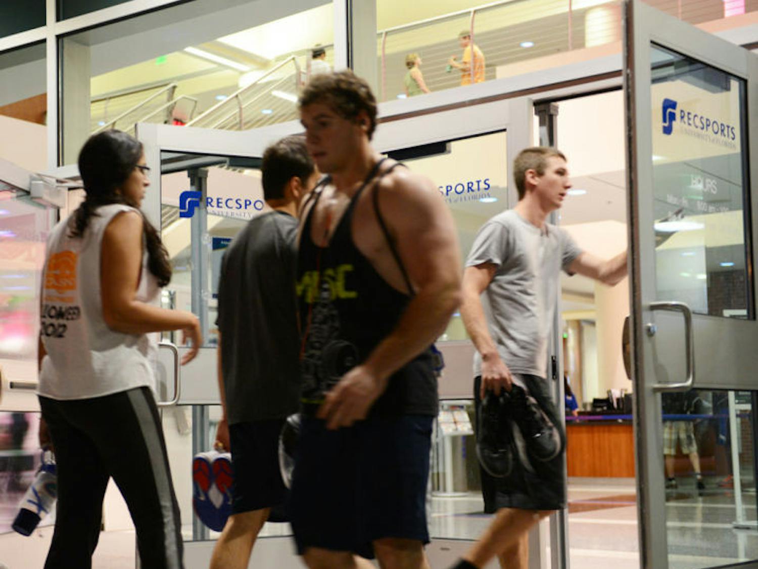 Students walk in and out of Southwest Recreation Center on Monday afternoon. About 39,000 people visited campus gyms last week.