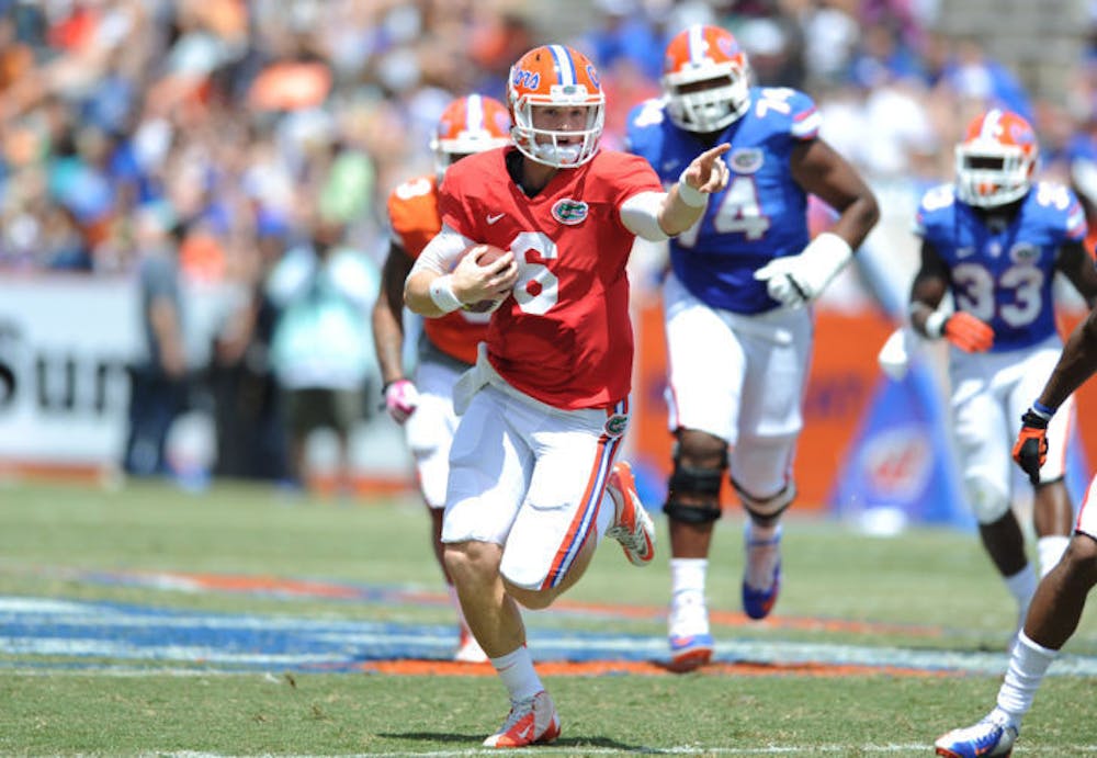 <p>Jeff Driskel (6) signals down the field as he scrambles during Florida’s Orange and Blue Debut on Saturday at Ben Hill Griffin Stadium. Driskel suffered a fractured fibula against Tennessee on Sept. 21, 2013.</p>