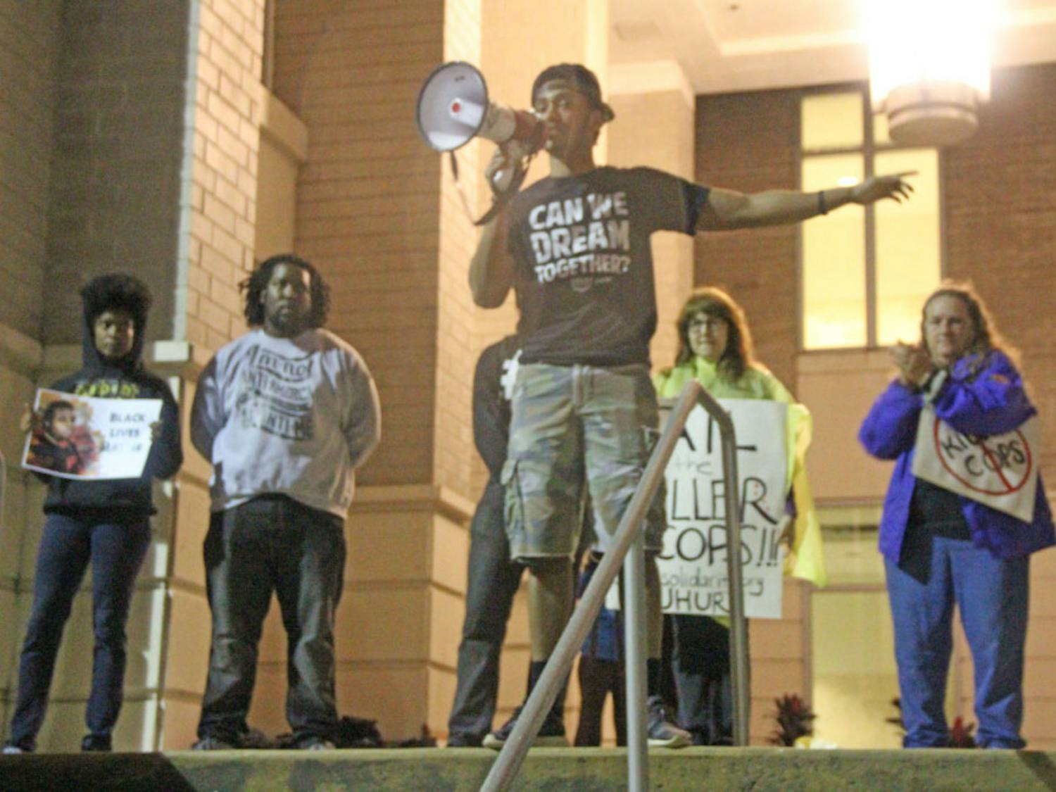 Azaari Mason, a 19-year-old UF political science junior, speaks to a crowd of people at the Gainesville Courthouse downtown&nbsp;Tuesday&nbsp;evening.&nbsp;